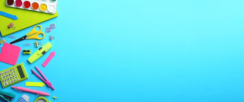 Colorful school stationery on light blue background, flat lay with space for text. Banner design