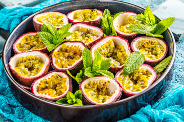 top view of fresh ripe delicious passion fruits with mint leaves