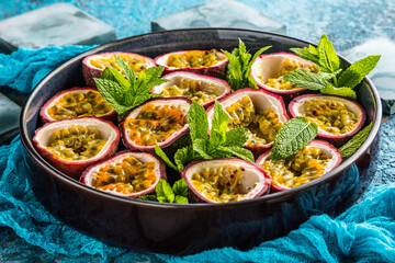 top view of fresh ripe delicious passion fruits with mint leaves
