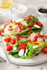 romaine lettuce topped with bacon tomato parmesan, sauce. healthy keto paleo diet lunch