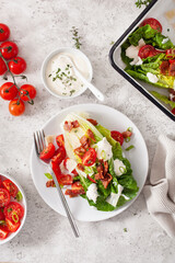 romaine lettuce topped with bacon tomato parmesan, sauce. healthy keto paleo diet lunch