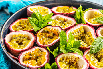top view of fresh ripe delicious passion fruits with mint leaves