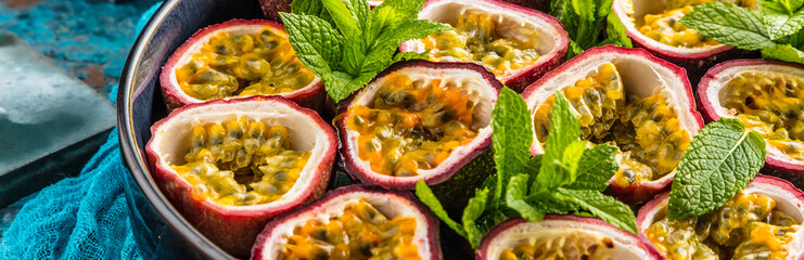 Fototapeta na wymiar top view of fresh ripe delicious passion fruits with mint leaves