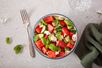 watermelon salad with feta cheese, cucumber and basil. healthy summer dessert