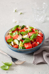 watermelon salad with feta cheese, cucumber and basil. healthy summer dessert