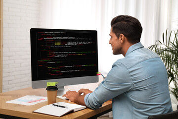 Professional programmer working with computer in office