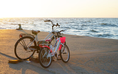 Bicycles on the beach with sunset background