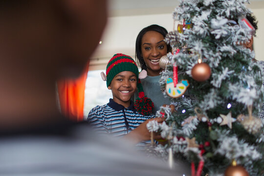 Portrait happy mother and son decorating Christmas tree
