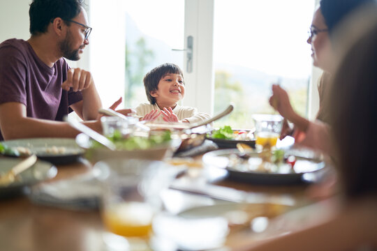 Happy family eating lunch at dining table