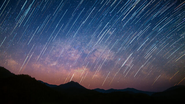 Beautiful landscape mountains in the starry night with Milky Way and startails background, Chiang mai , Thailand