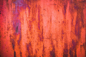 The old iron background is painted in red, pink, purple with rust and chips.