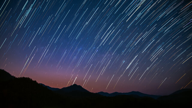 Beautiful landscape mountains  in the starry night with startails background, Chiang mai , Thailand