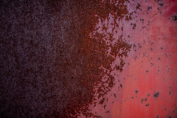 The old iron background is painted in red, pink, purple with rust and chips.