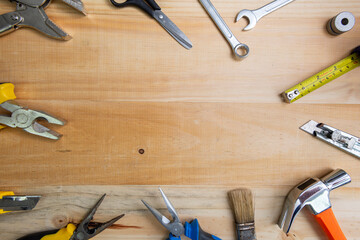 Working instruments scattered on a wooden surface with space for text in the center