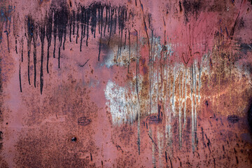 The old iron background is painted in red, pink, purple with rust and chips.