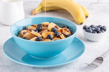 Trendy breakfast with mini pancakes, blueberries and chocolate chips.