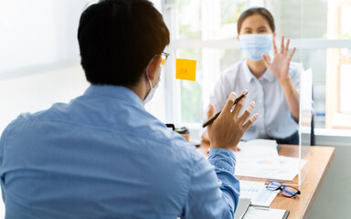 Coronavirus concept , Office workers wearing mask working together with infection protect.