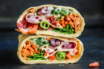 tortilla or burrito wrap stuffing vegetables vegetarian pita bread Menu concept serving size. food background top view copy space organic healthy eating
