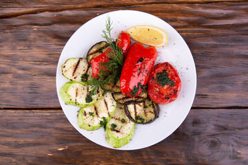 Grilled fried vegetables with seasonings and greens