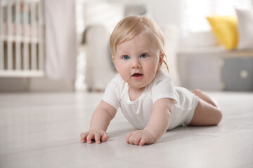 Cute little baby on floor at home