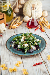 Fototapeta na wymiar Salad with boiled beets, cheese and herbs