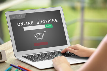 Fototapeta na wymiar Woman using laptop for online shopping indoors, closeup