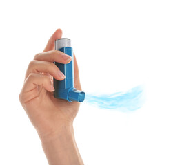 Woman holding asthma inhaler with steam on white background, closeup