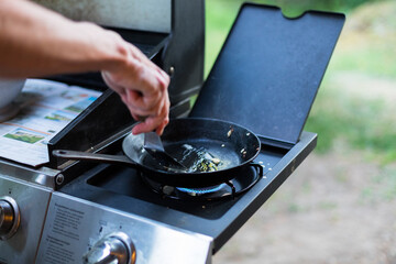 Making crêpes on gas burner with cast iron pan