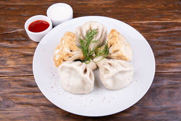 Assorted from khinkali, served with ketchup and sour cream