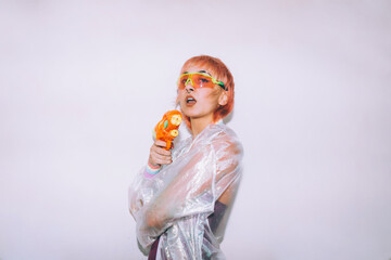 Retro futuristic woman pointing gun at camera