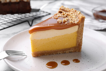Piece of delicious cake with caramel on plate, closeup