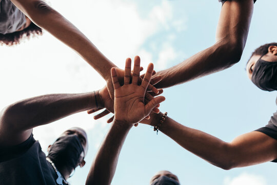 Group of friends stacking hands against racism. Black Lives Matters concept.