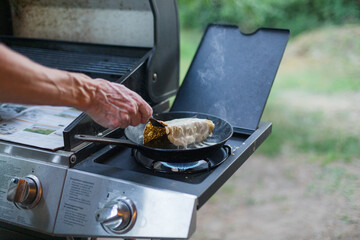 Making crêpes on gas burner with cast iron pan