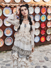 Beautiful women in the old city.Outdoor portrait of pretty brunette.Girl wearing stylish boho chic outfit.