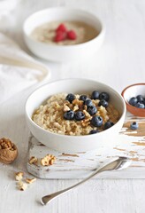 Overnight oatmeal porridge with fresh blueberries and walnuts. Close-up