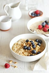 Overnight oatmeal porridge with fresh blueberries and walnuts. Close-up