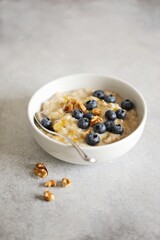 Overnight oatmeal porridge with fresh blueberries and walnuts. Close-up