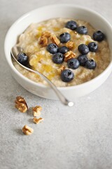Overnight oatmeal porridge with fresh blueberries and walnuts. Close-up