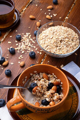 breakfasr with oatmeal porridge with blueberries, fruits,  almonds and coconut milk. Healthy and tasty vegan breakfast. top view.