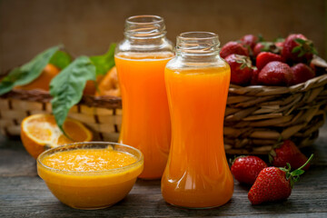 ripe fruit in a basket and fresh orange juice