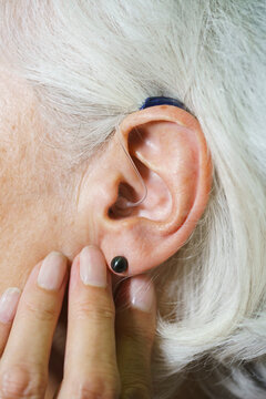 Cropped image of senior woman wearing hearing aid