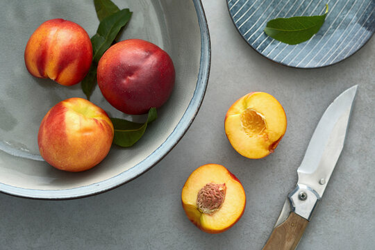 Close-up of peaches on table and container