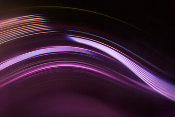 Full frame abstract image of purple light trails against black background