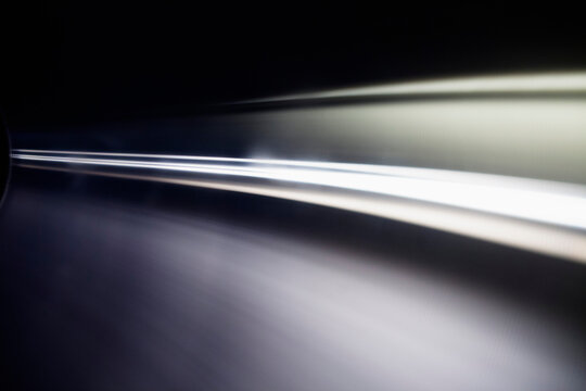 Abstract light trails against black background