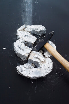 High angle view of broken concrete section sign with hammer on table