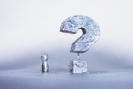Close-up of concrete question mark against gray background
