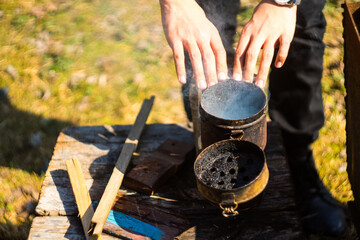 A beekeeper preparing smoker for bee control