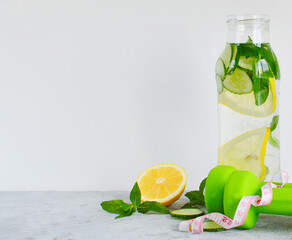 A refreshing drink of lemon, mint, cucumber in a glass bottle and a glass. Sassy diet water. The concept of a healthy diet, diet.