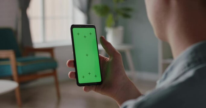 Close up shot of a man using smartphone with chroma key green screen, scrolling through social media or online shopping - technology, connection concept 4k template