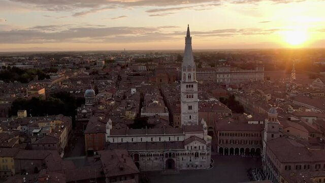 modena aerial view of duomo cathedral at sunrise,fly orbit over city center and piazza grande